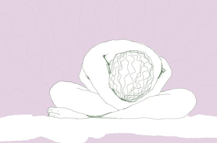 A woman folds over her crossed legs in anguish